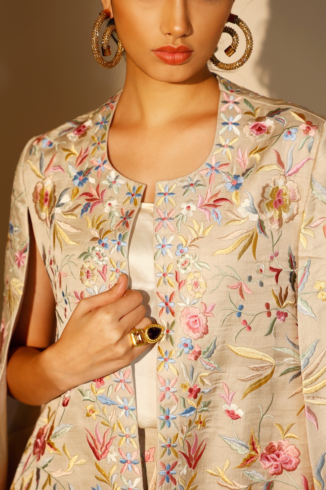 A model showcasing Beige Bloom Cape by Ashtar from Ashtar's collection