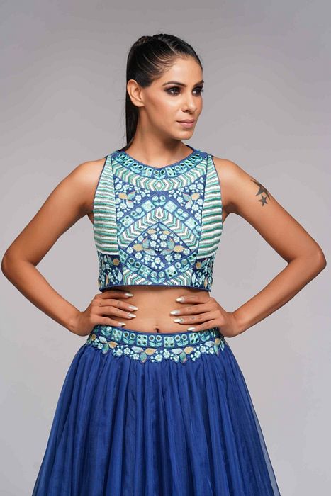 A model showcasing Mirror Work Thread Work Blue Organza Lehenga For Haldi Or Mehandi by Shruti S Label from Shruti S Label's collection