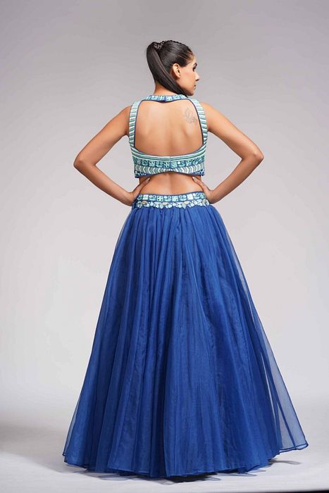 A model showcasing Mirror Work Thread Work Blue Organza Lehenga For Haldi Or Mehandi by Shruti S Label from Shruti S Label's collection