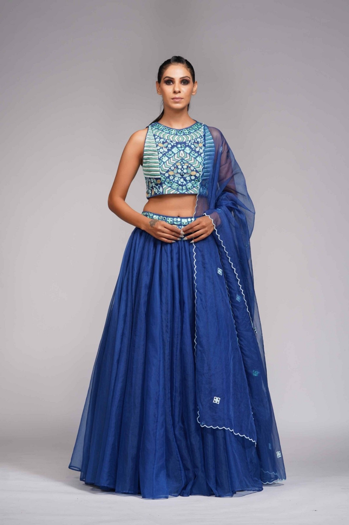 A model showcasing Mirror Work Thread Work Blue Organza Lehenga For Haldi Or Mehandi Feature image by Shruti S Label from Shruti S Label's collection