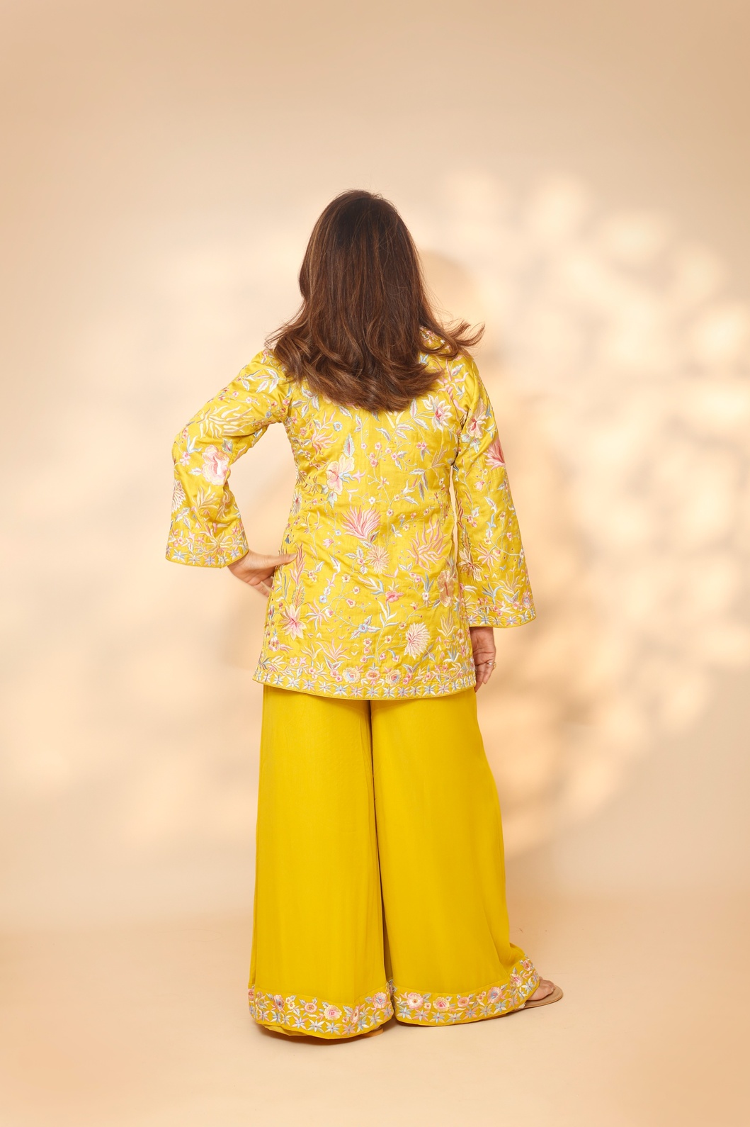 A model showcasing Yellow Blossom Sharara Set by Ashtar from Ashtar's collection
