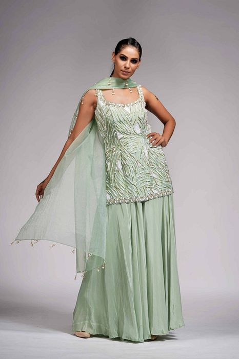 A model showcasing White Pearl Gold Embroidery Sharara Suit In Sea Green by Shruti S Label from Shruti S Label's collection