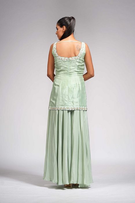 A model showcasing White Pearl Gold Embroidery Sharara Suit In Sea Green by Shruti S Label from Shruti S Label's collection