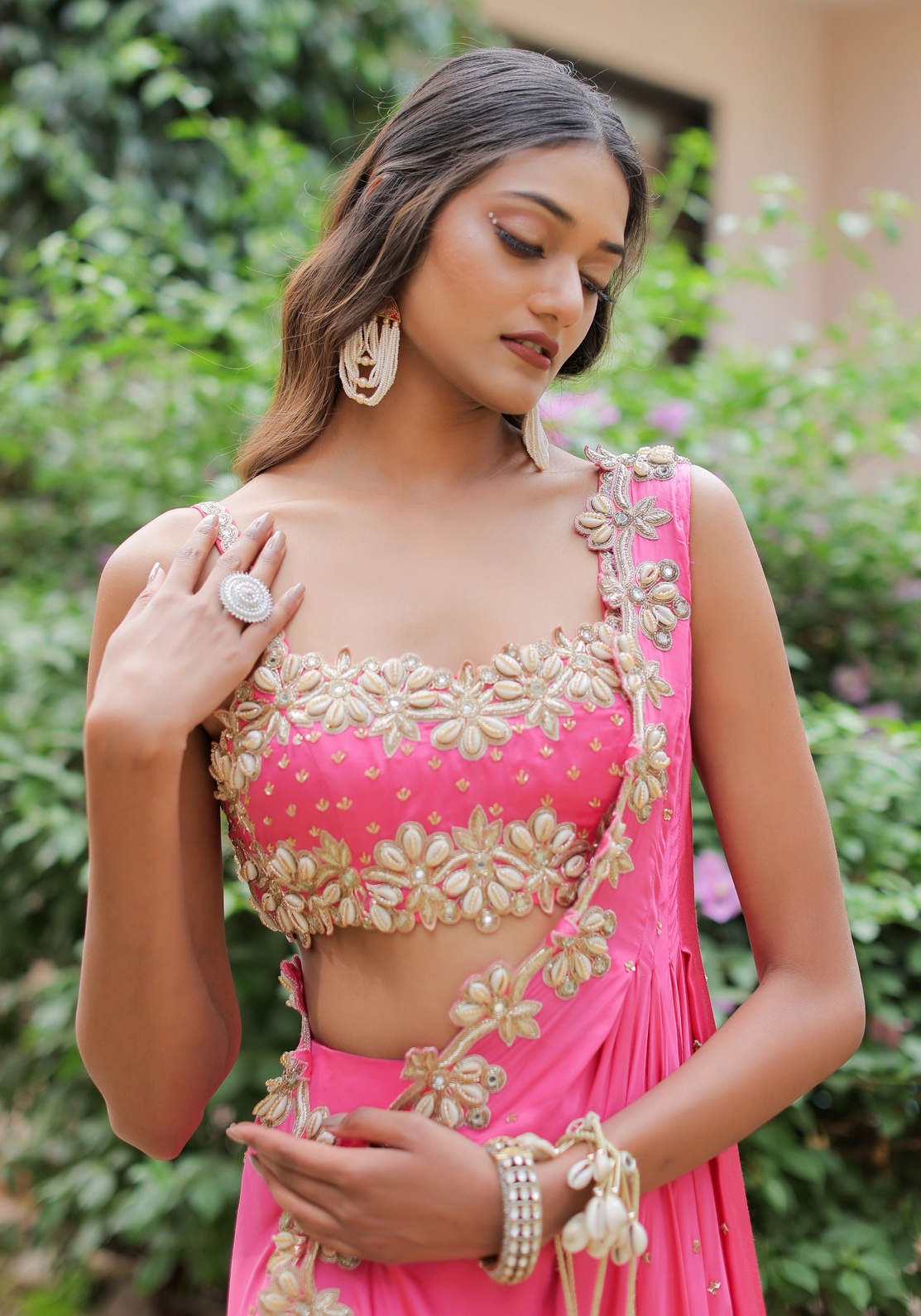 A model showcasing Pink Mirror And Cowrie Embroidered Cape Set by Foram Patel from Foram Patel's collection