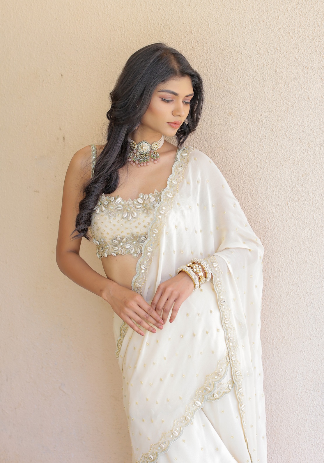 A model showcasing Cream Embroidered Mumtaz Saree Set by Foram Patel from Foram Patel's collection