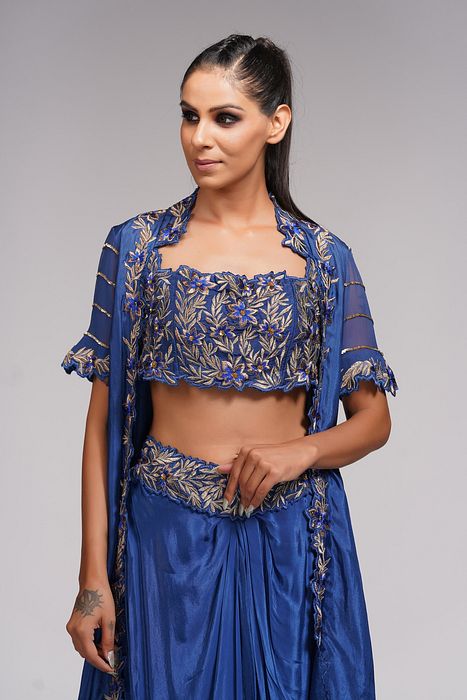 A model showcasing Dhoti Skirt With Croptop And Cape In Blue by Shruti S Label from Shruti S Label's collection