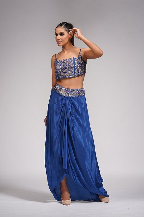 A model showcasing Dhoti Skirt With Croptop And Cape In Blue by Shruti S Label from Shruti S Label's collection