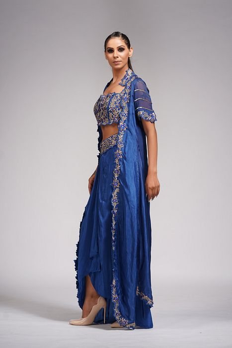 A model showcasing Dhoti Skirt With Croptop And Cape In Blue by Shruti S Label from Shruti S Label's collection