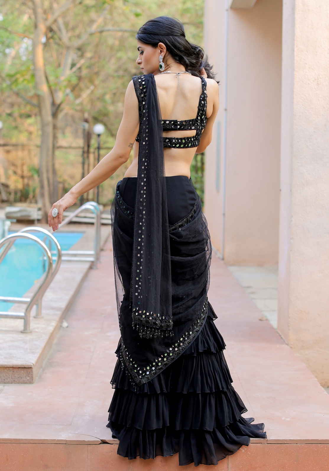 A model showcasing Black Mirror Embroidered Ruffle Saree Set by Foram Patel from Foram Patel's collection
