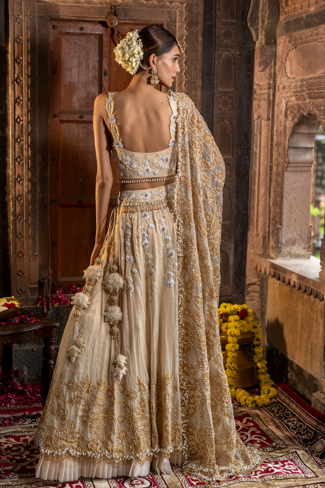 A model showcasing Ivory And Golden 3 Piece Lehenga Set by Farha Syed from Farha Syed's collection