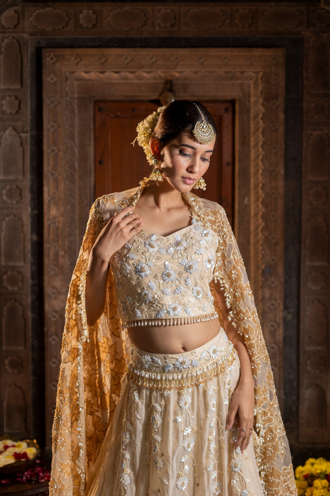 A model showcasing Ivory And Golden 3 Piece Lehenga Set by Farha Syed from Farha Syed's collection
