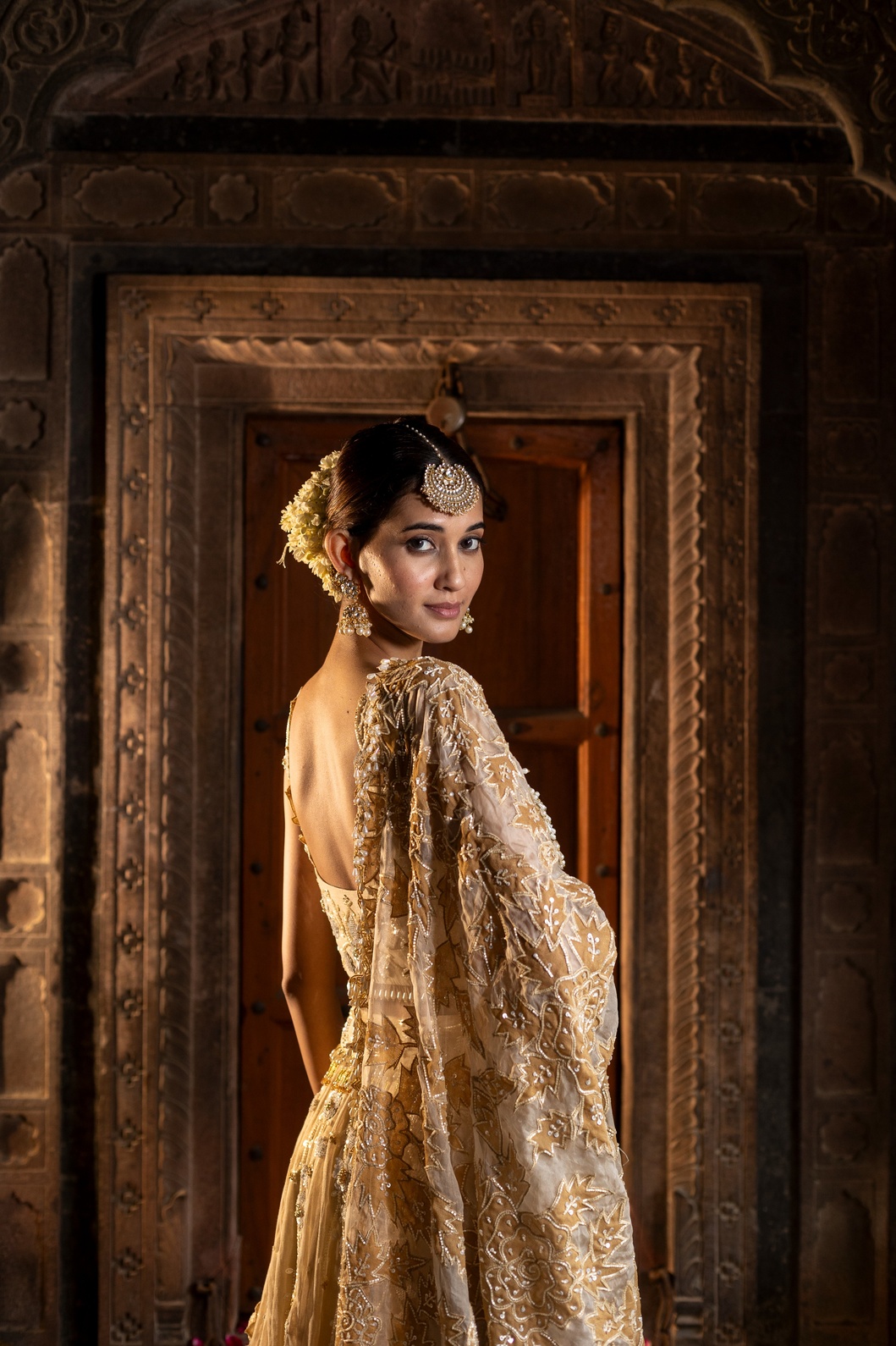 A model showcasing Ivory And Golden 3 Piece Lehenga Set by Farha Syed from Farha Syed's collection