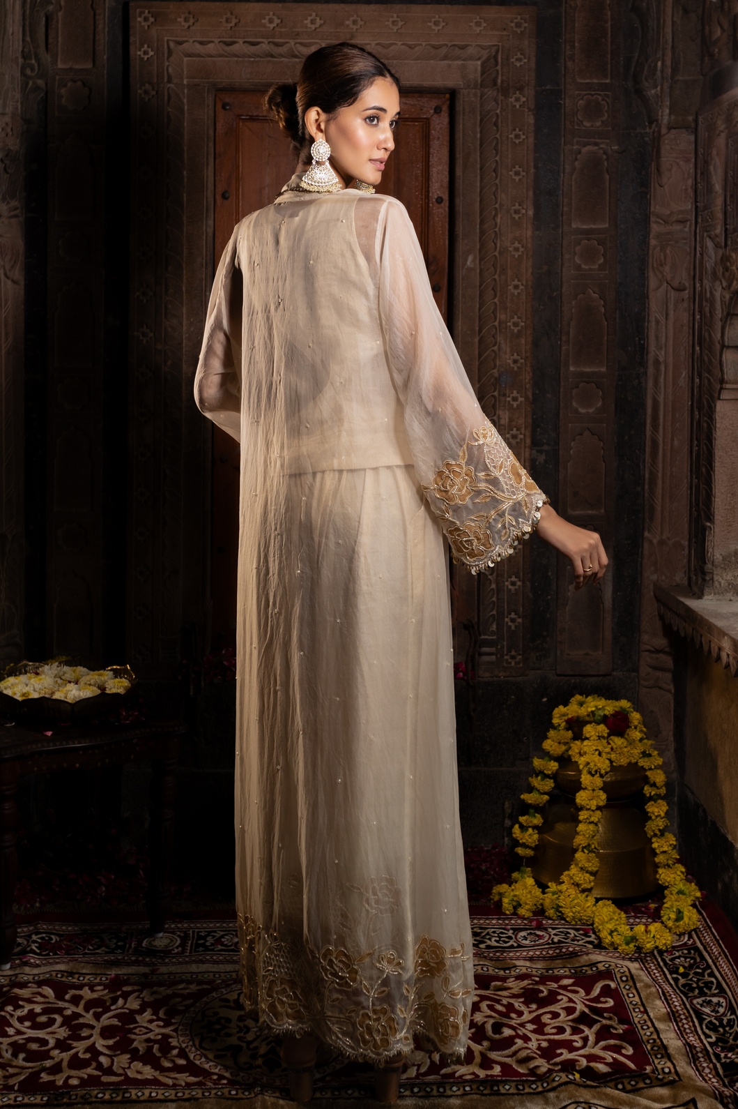 A model showcasing Ivory And Golden 3 Piece Jacket Set by Farha Syed from Farha Syed's collection