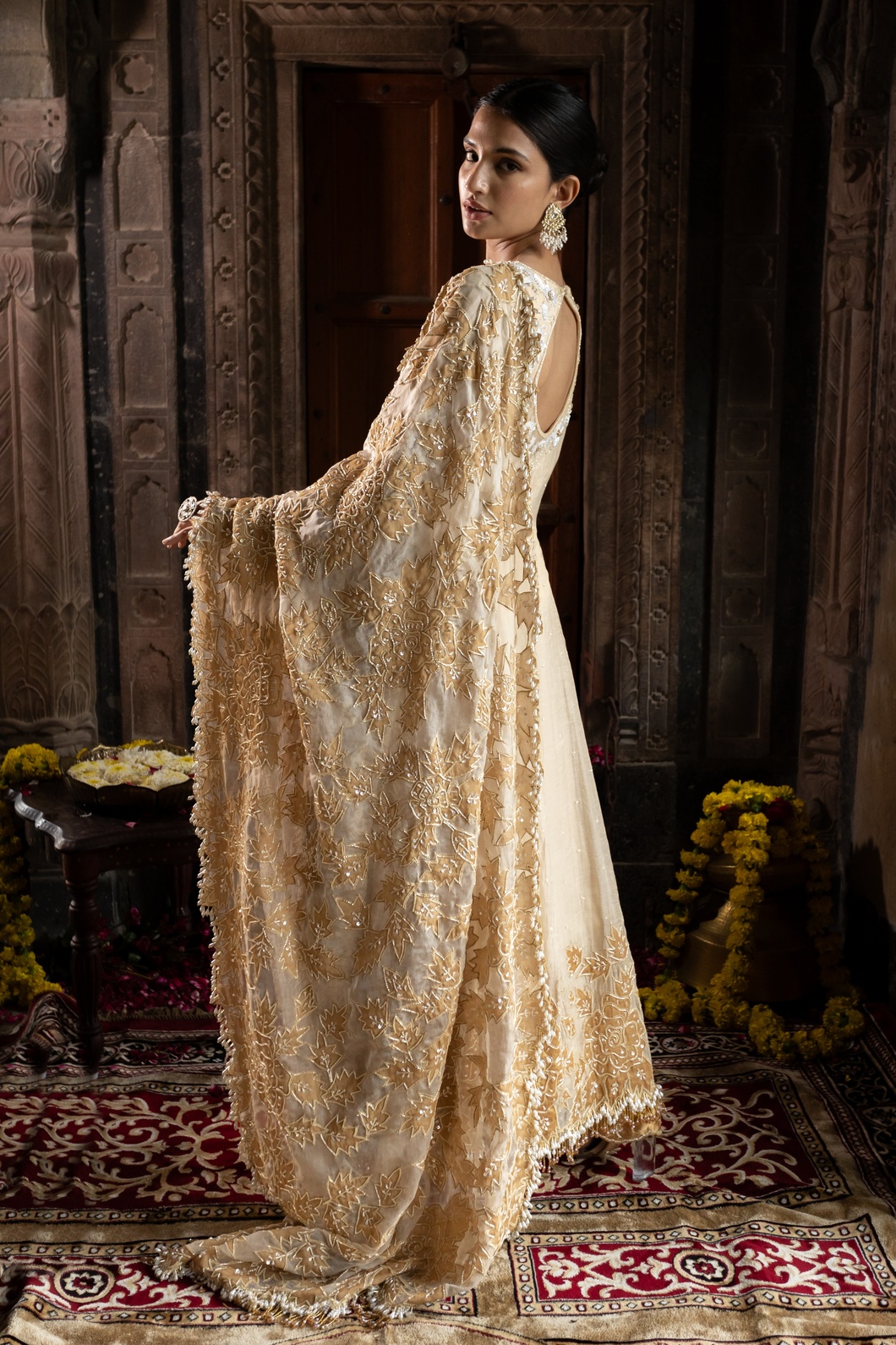 A model showcasing Ivory And Golden Anarkali Palazzo Set by Farha Syed from Farha Syed's collection