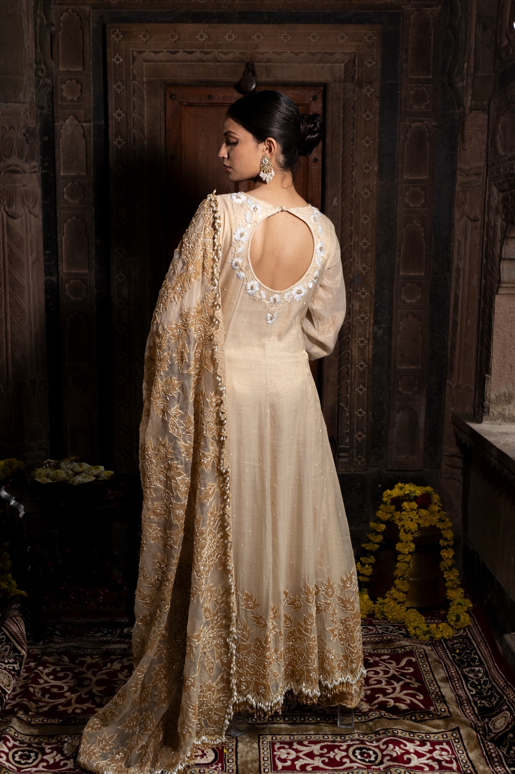 A model showcasing Ivory And Golden Anarkali Palazzo Set by Farha Syed from Farha Syed's collection