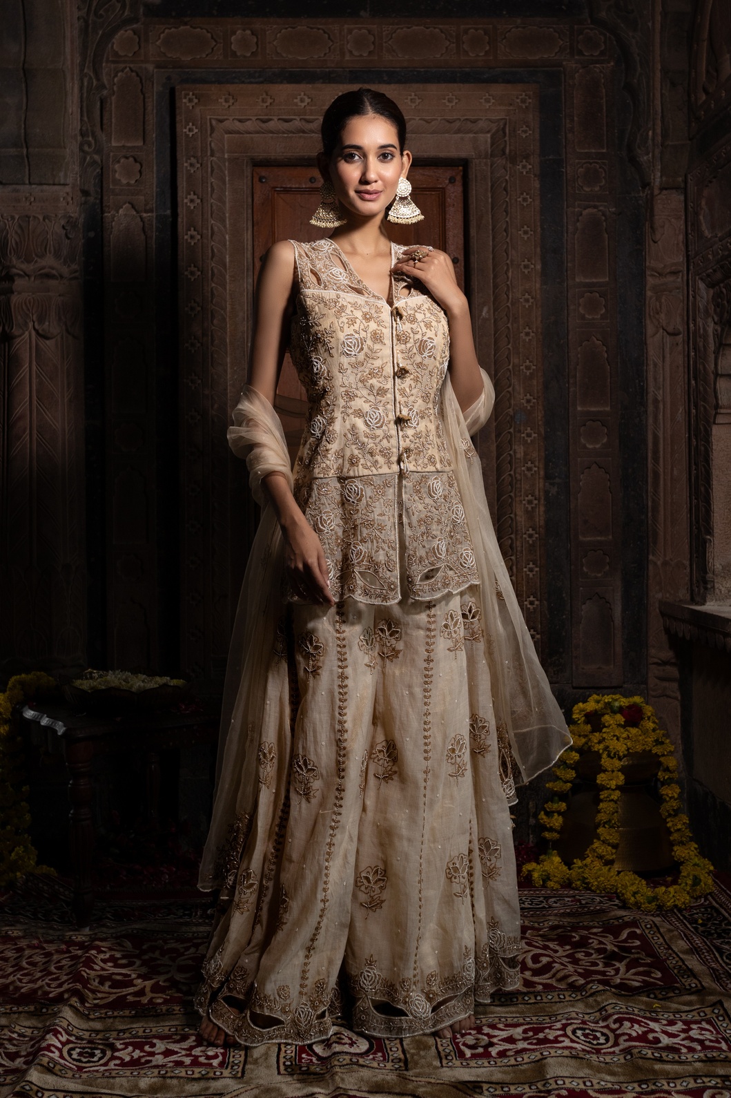 A model showcasing Beige Hand Embroidered Kurta With Sharara Set by Farha Syed from Farha Syed's collection