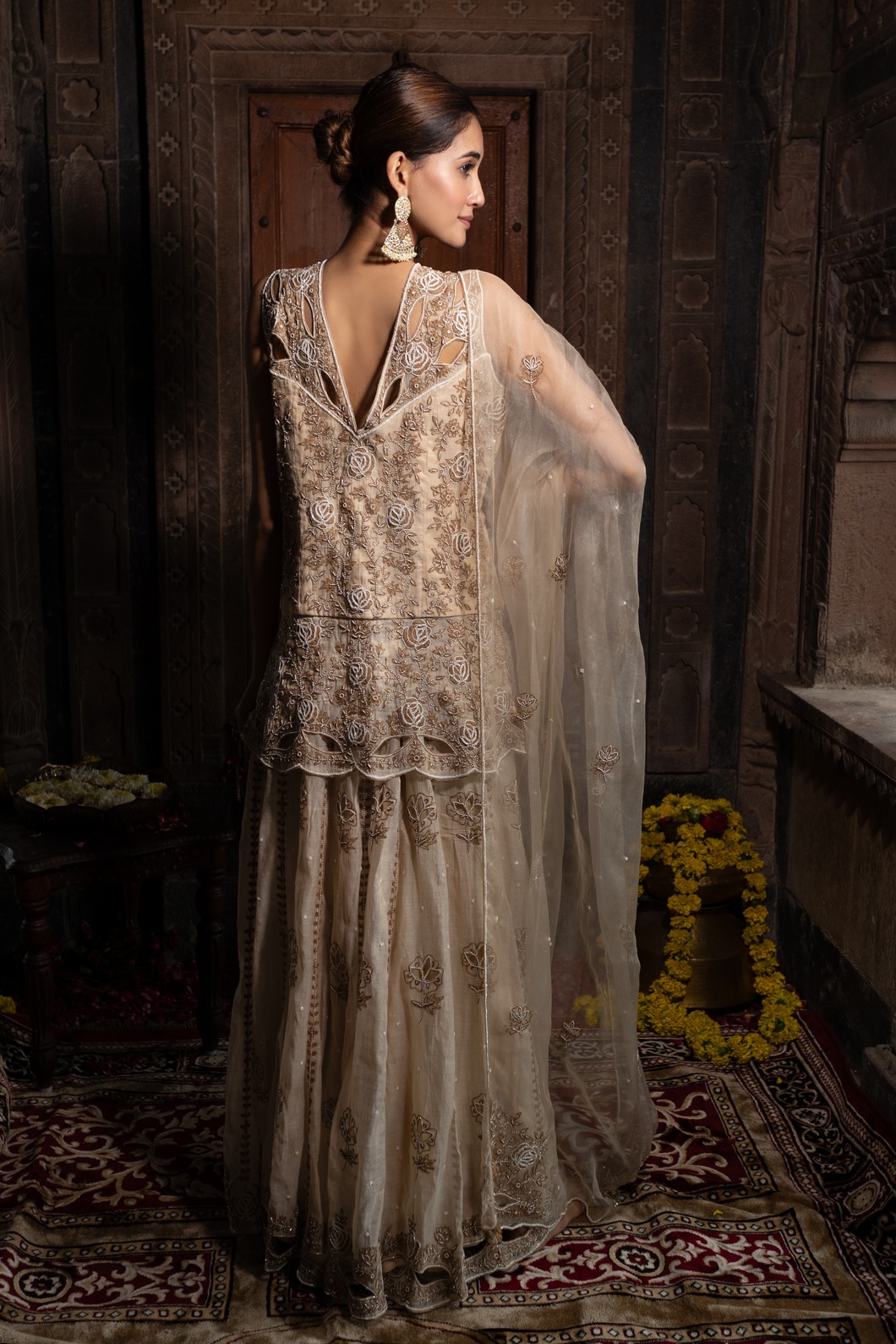 A model showcasing Beige Hand Embroidered Kurta With Sharara Set by Farha Syed from Farha Syed's collection