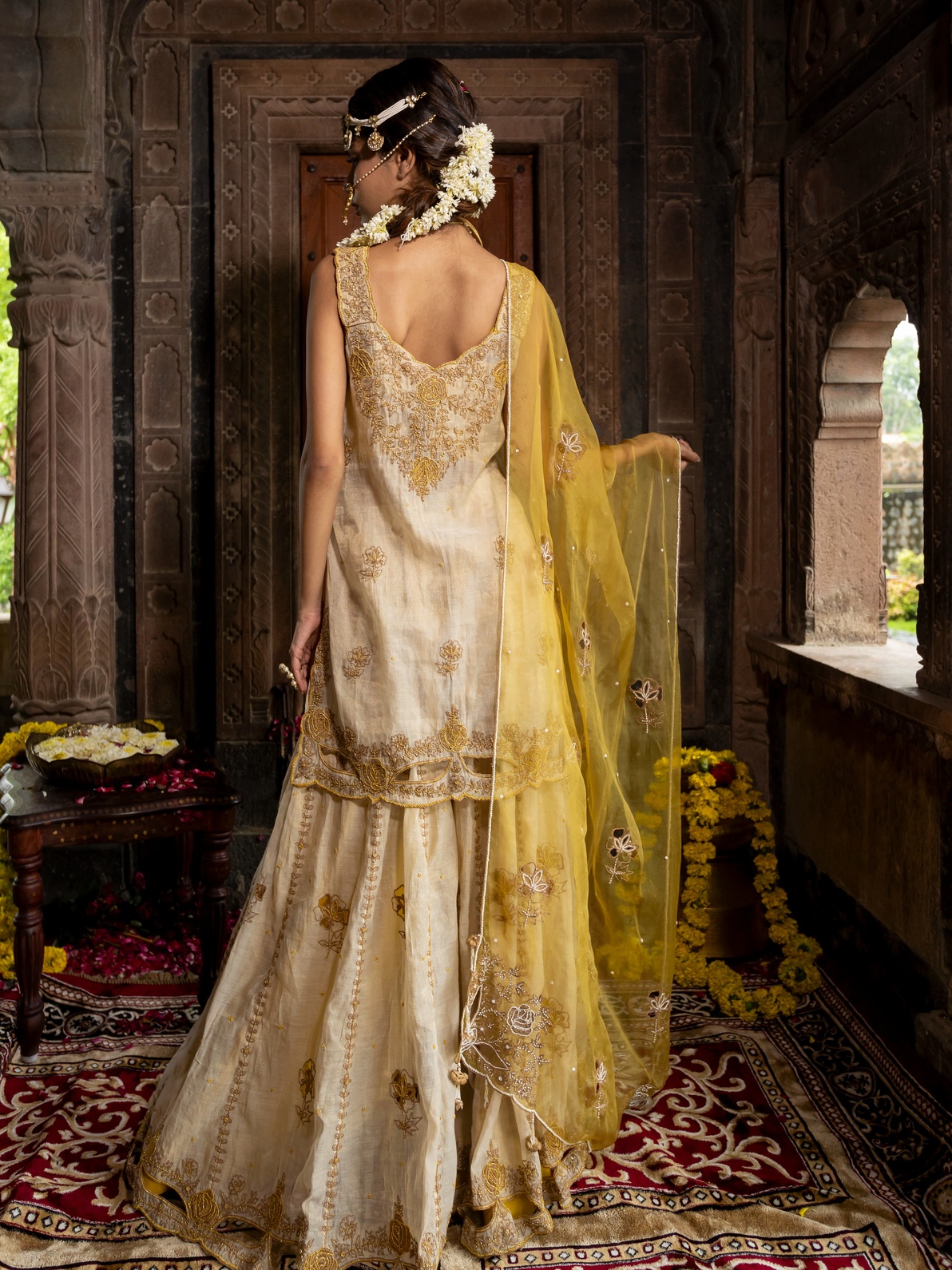 A model showcasing Beige Kurta And Sharara Set With Yellow Dupatta by Farha Syed from Farha Syed's collection