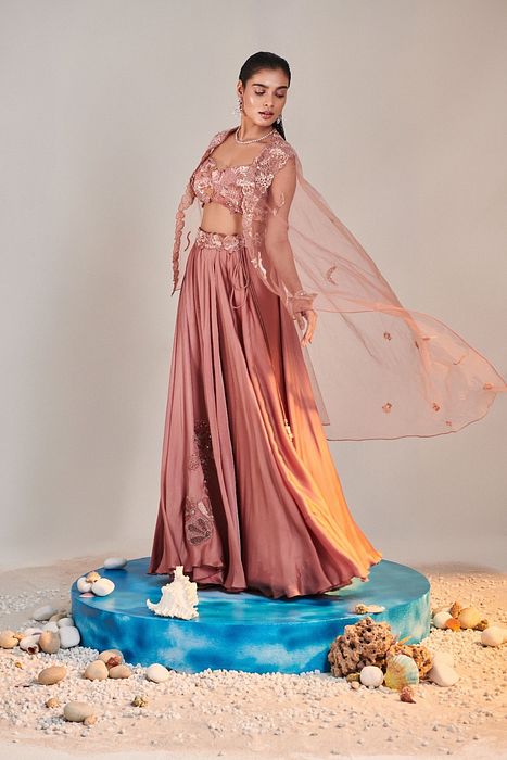 A model showcasing Salmon Pink Cutwork Blouse Applique Lehenga by One Knot One from One Knot One's collection