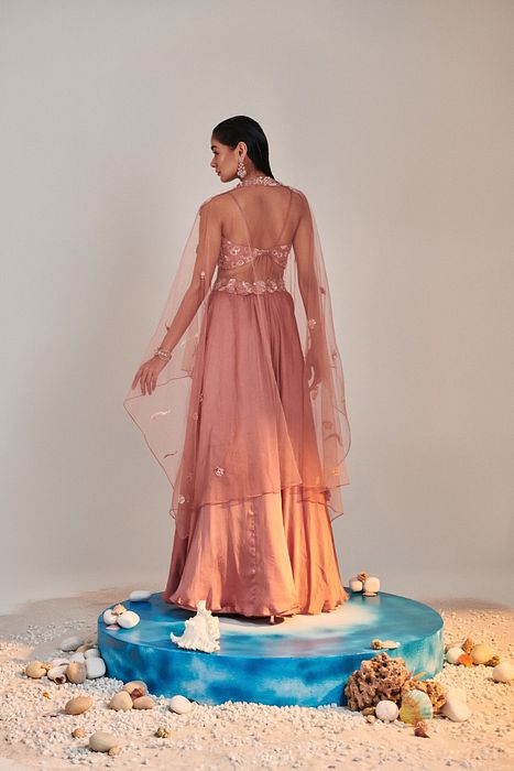 A model showcasing Salmon Pink Cutwork Blouse Applique Lehenga by One Knot One from One Knot One's collection