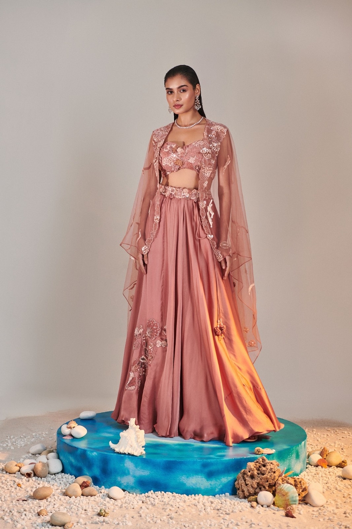 A model showcasing Salmon Pink Cutwork Blouse Applique Lehenga Feature image by One Knot One from One Knot One's collection