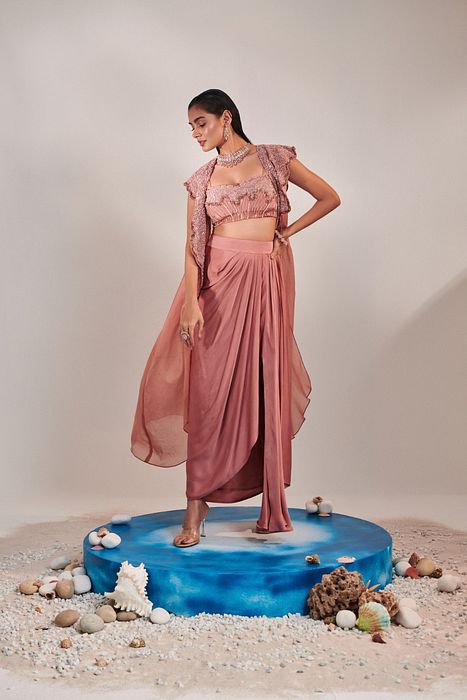 A model showcasing Salmon Pink Cape And Embroidred Blouse by One Knot One from One Knot One's collection
