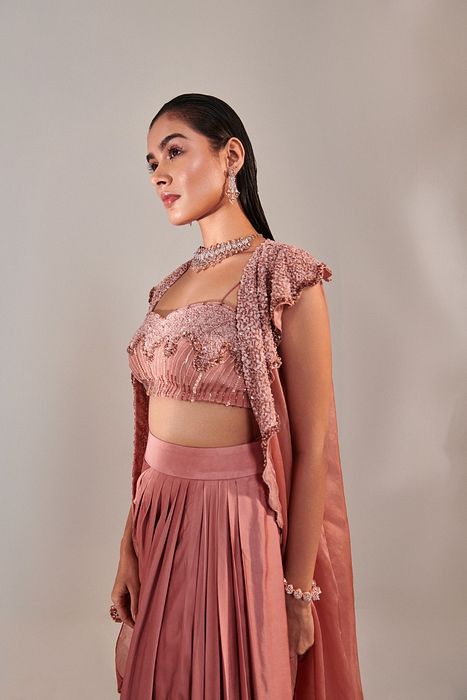 A model showcasing Salmon Pink Cape And Embroidred Blouse by One Knot One from One Knot One's collection