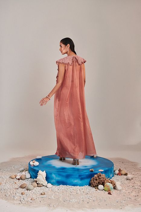 A model showcasing Salmon Pink Cape And Embroidred Blouse by One Knot One from One Knot One's collection