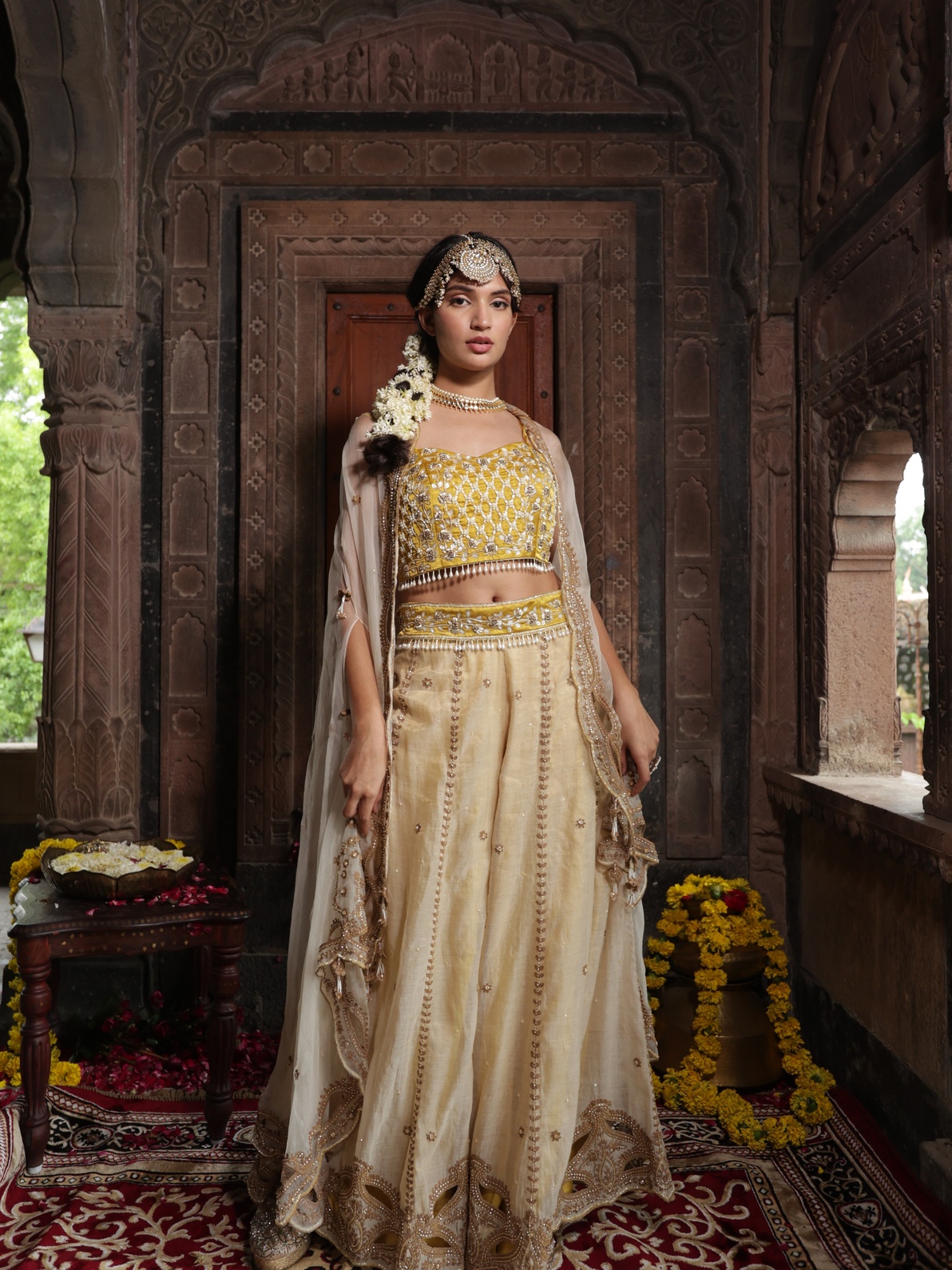 A model showcasing Yellow Blouse With Beige Pants Cape Set by Farha Syed from Farha Syed's collection