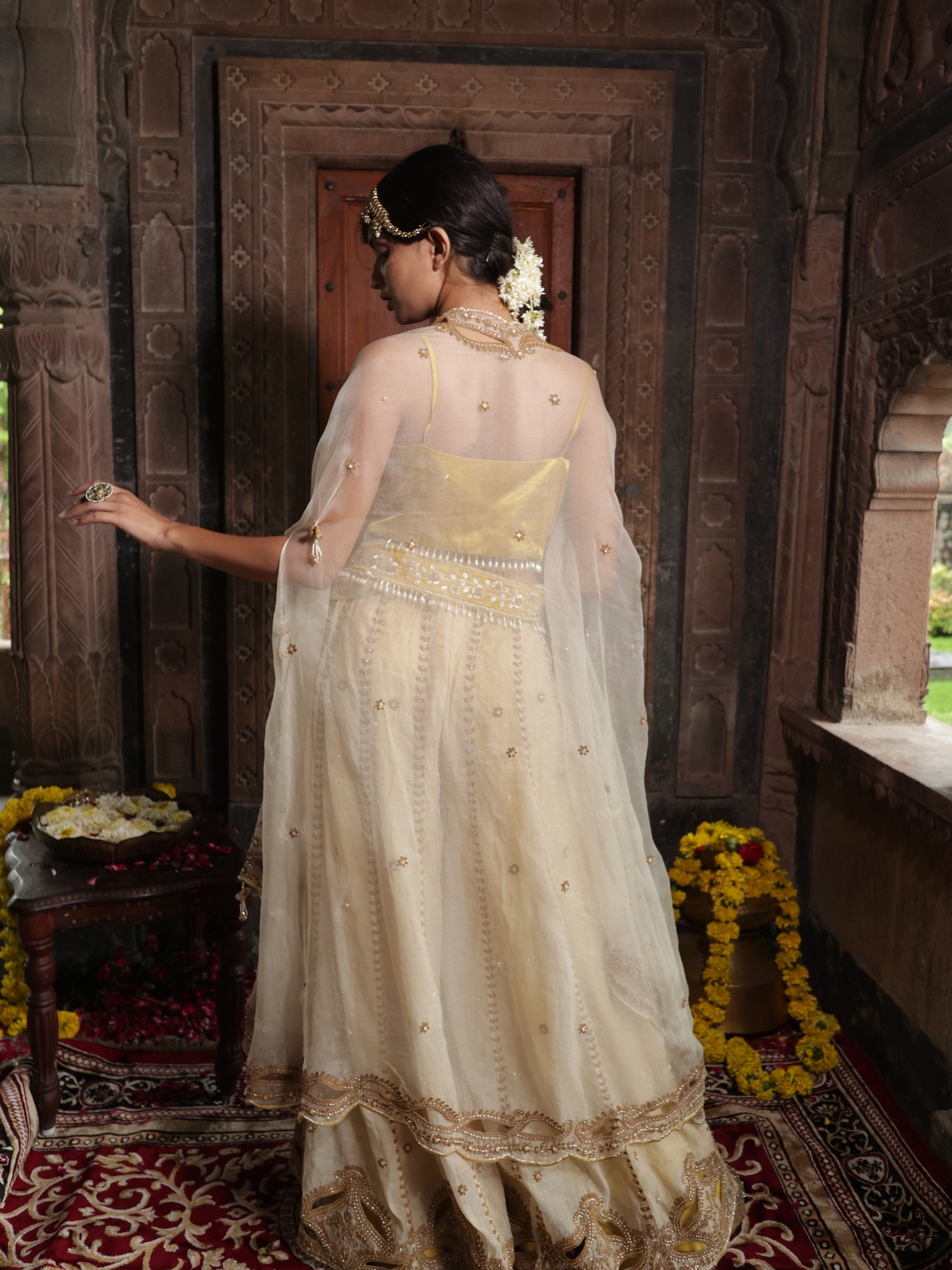 A model showcasing Yellow Blouse With Beige Pants Cape Set by Farha Syed from Farha Syed's collection