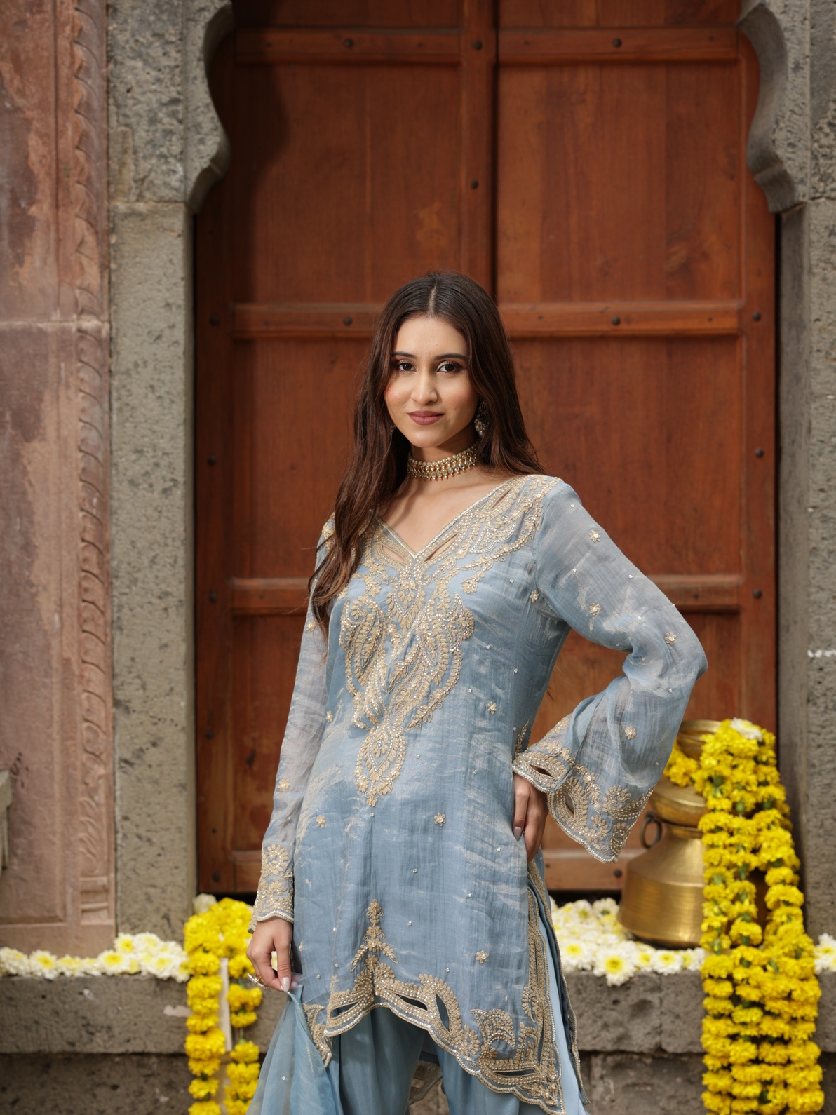 A model showcasing Blue Hand Embroidered Kurta Dhoti Set by Farha Syed from Farha Syed's collection