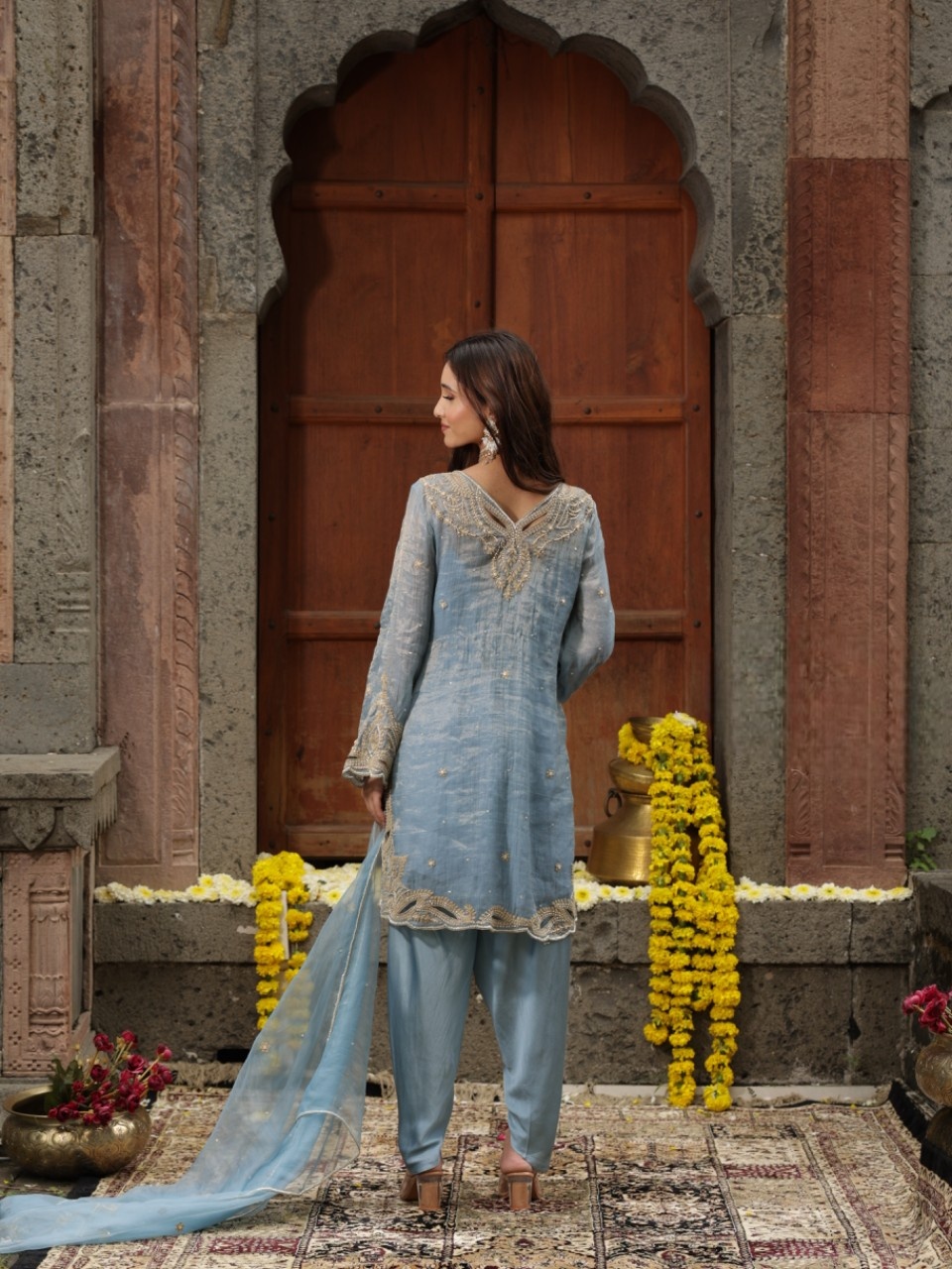 A model showcasing Blue Hand Embroidered Kurta Dhoti Set by Farha Syed from Farha Syed's collection