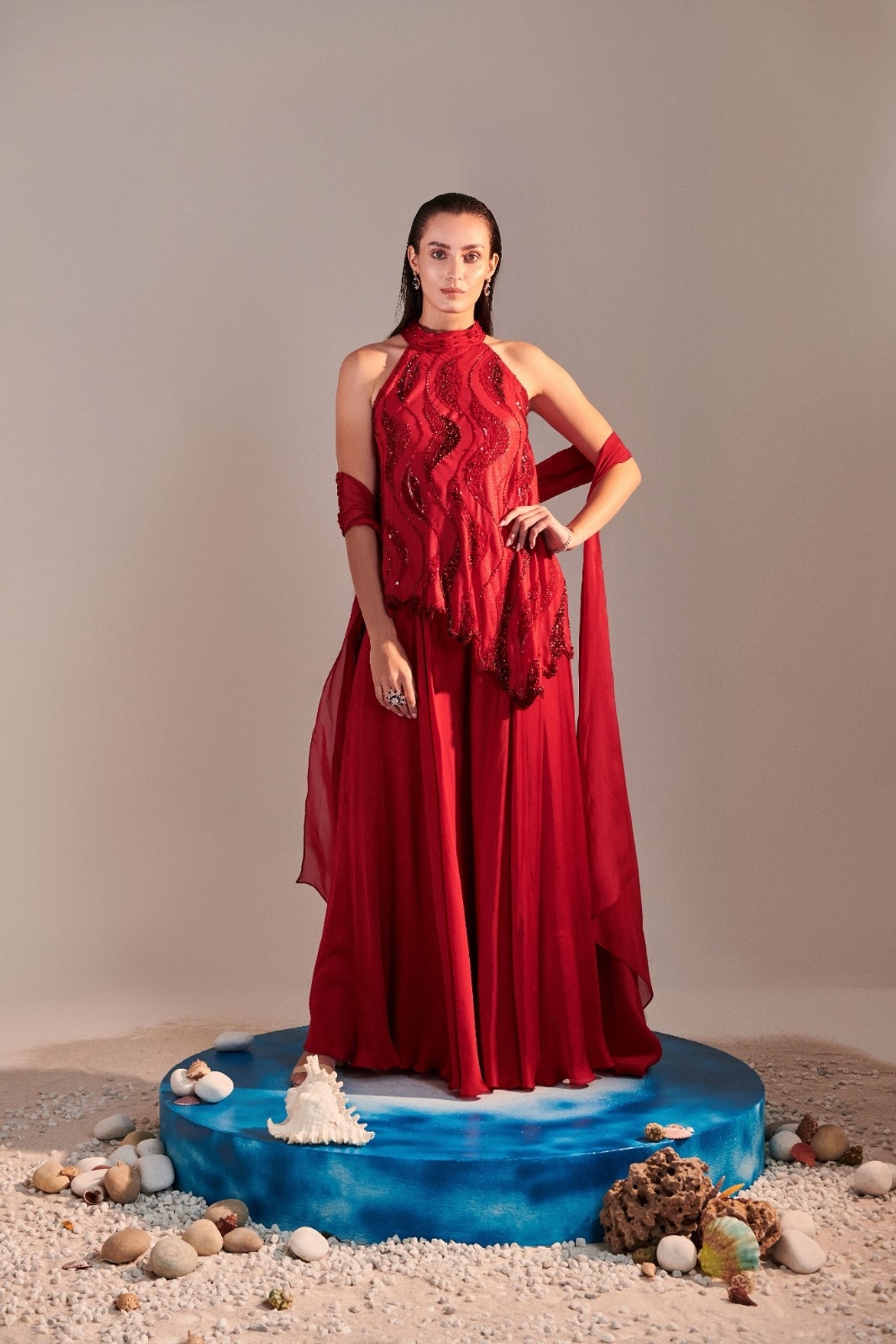 A model showcasing Scarlet Red Cutwork Asymmetric Tunic And Twisted Pleats Dupatta Feature image by One Knot One from One Knot One's collection