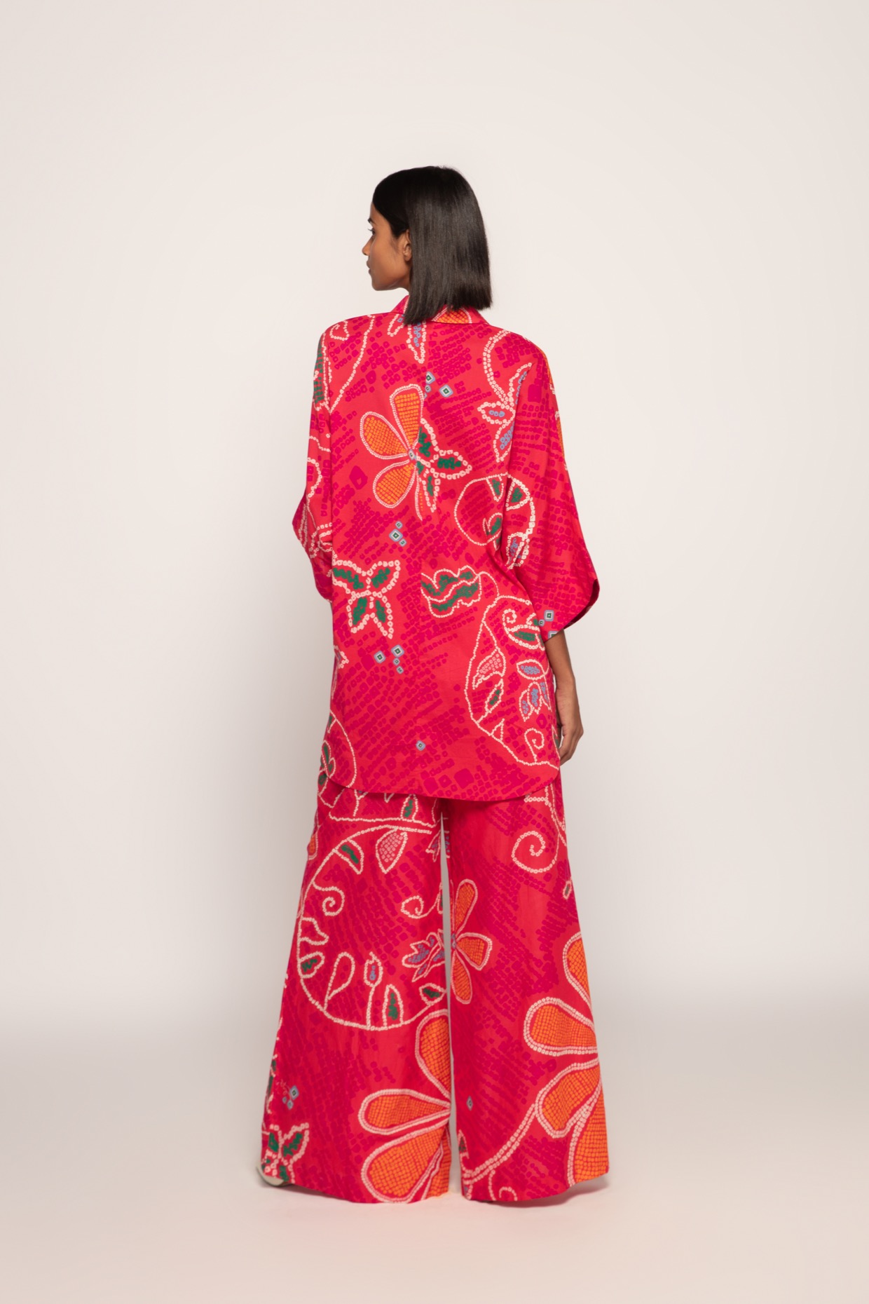 A model showcasing Marigold Bandhani Print Shirt by Saaksha And Kinni from Saaksha And Kinni's collection