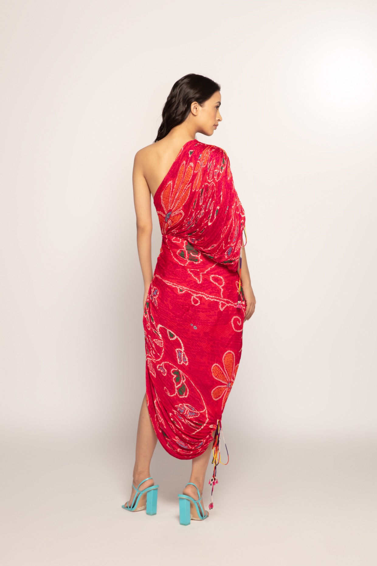 A model showcasing Bandhani Print One Shoulder Dress by Saaksha And Kinni from Saaksha And Kinni's collection