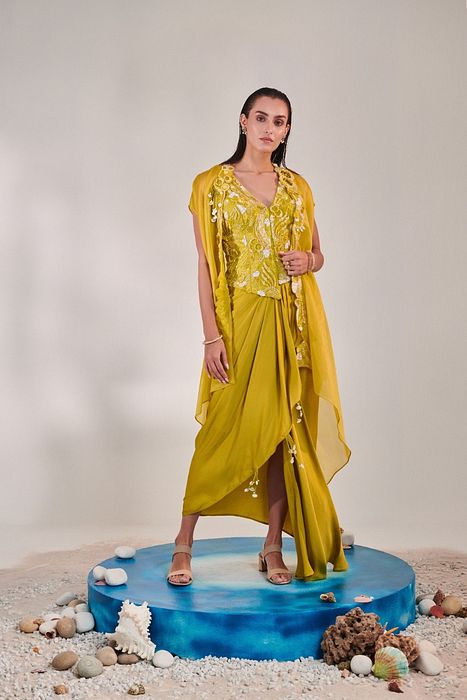 A model showcasing Skirt Set With Cape In Lime Yellow by One Knot One from One Knot One's collection
