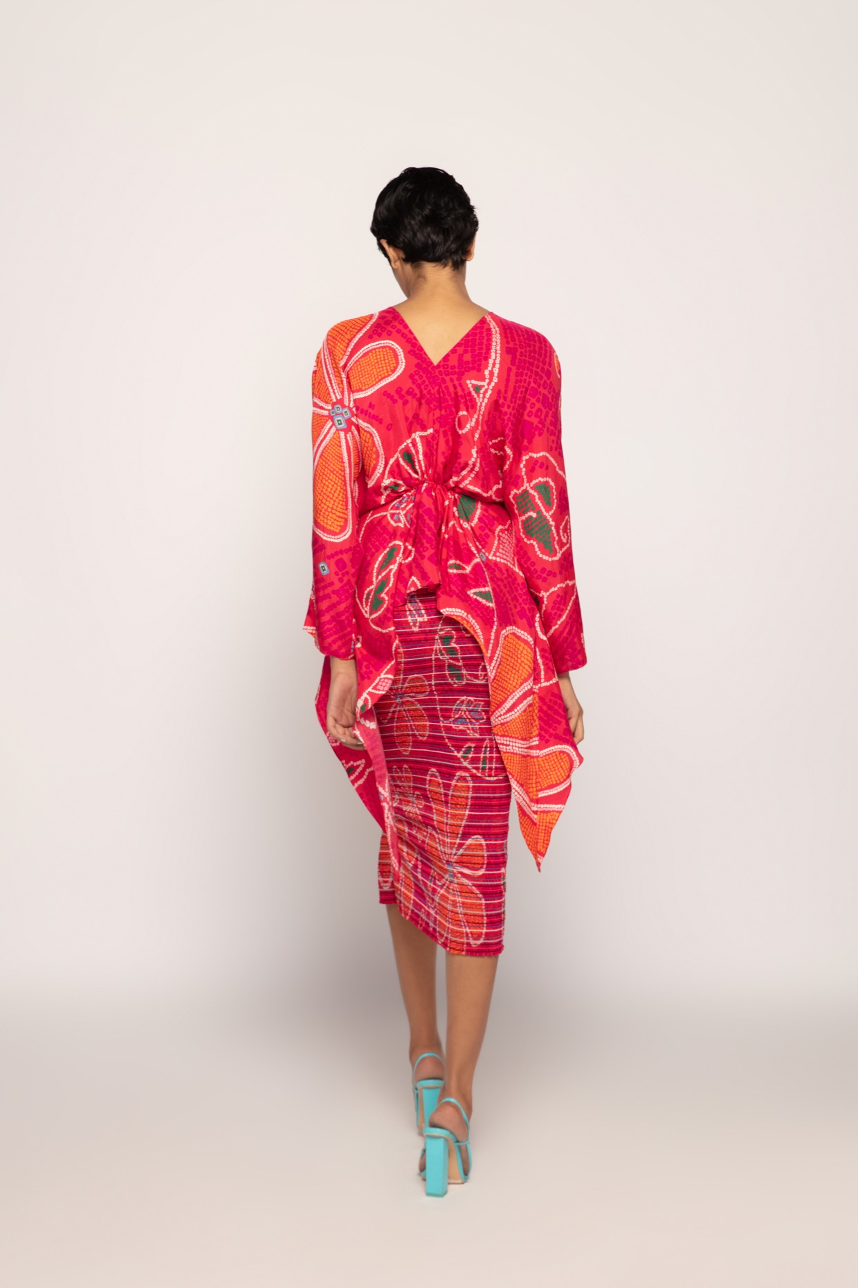 A model showcasing Marigold Bandhani Asymmetric Blouse by Saaksha And Kinni from Saaksha And Kinni's collection