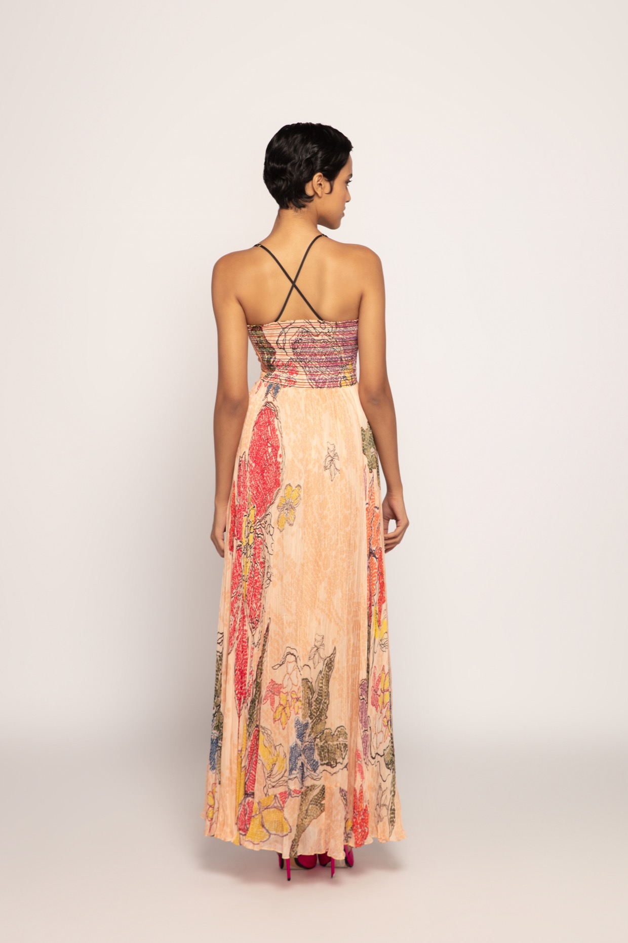 A model showcasing Periwinkle Bandhani Print Peach Maxi Dress by Saaksha And Kinni from Saaksha And Kinni's collection