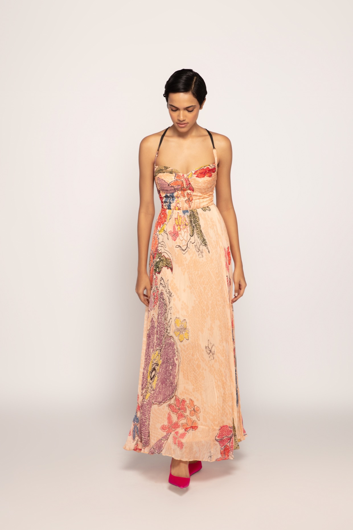 A model showcasing Periwinkle Bandhani Print Peach Maxi Dress by Saaksha And Kinni from Saaksha And Kinni's collection