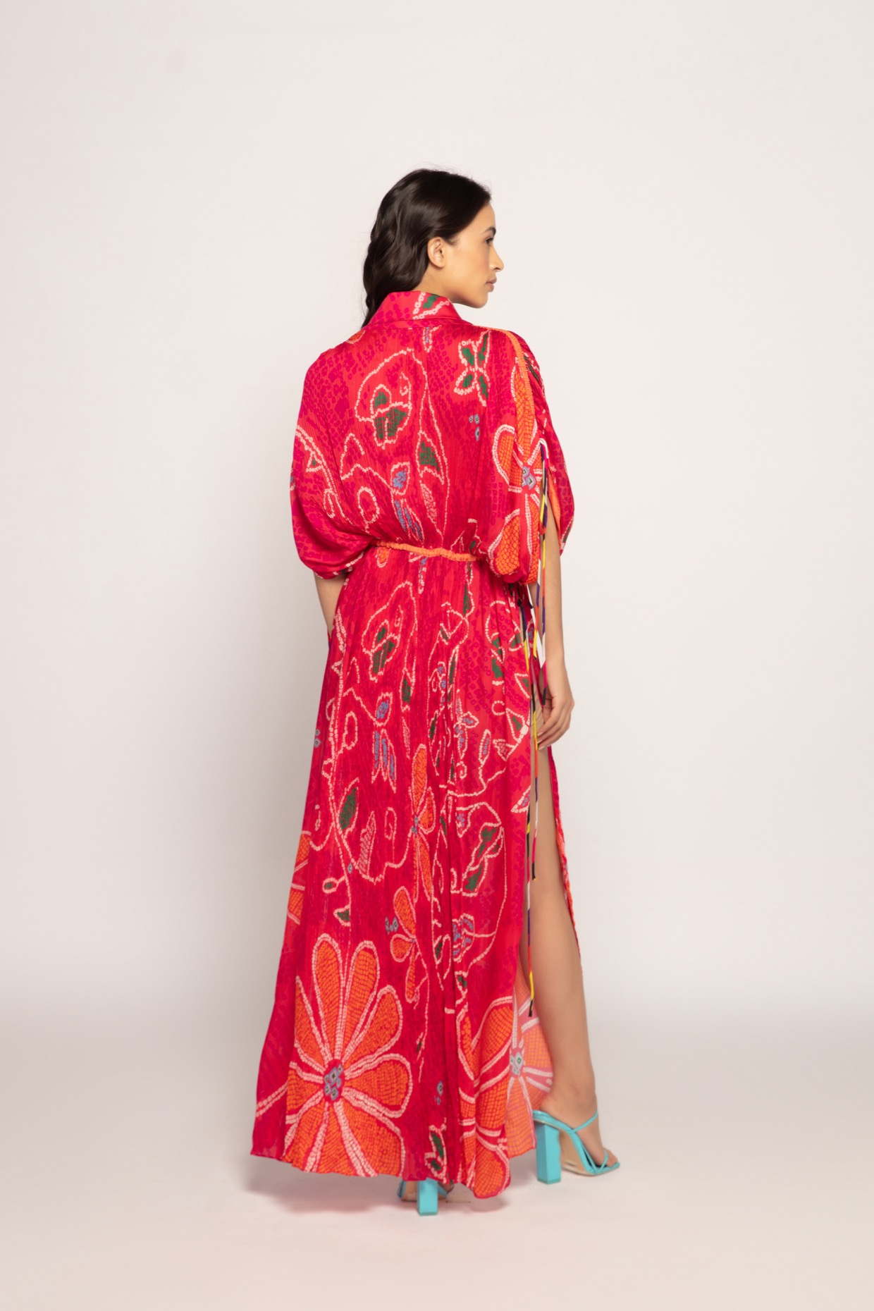 A model showcasing Marigold Bandhani Pleated Kaftan Dress by Saaksha And Kinni from Saaksha And Kinni's collection
