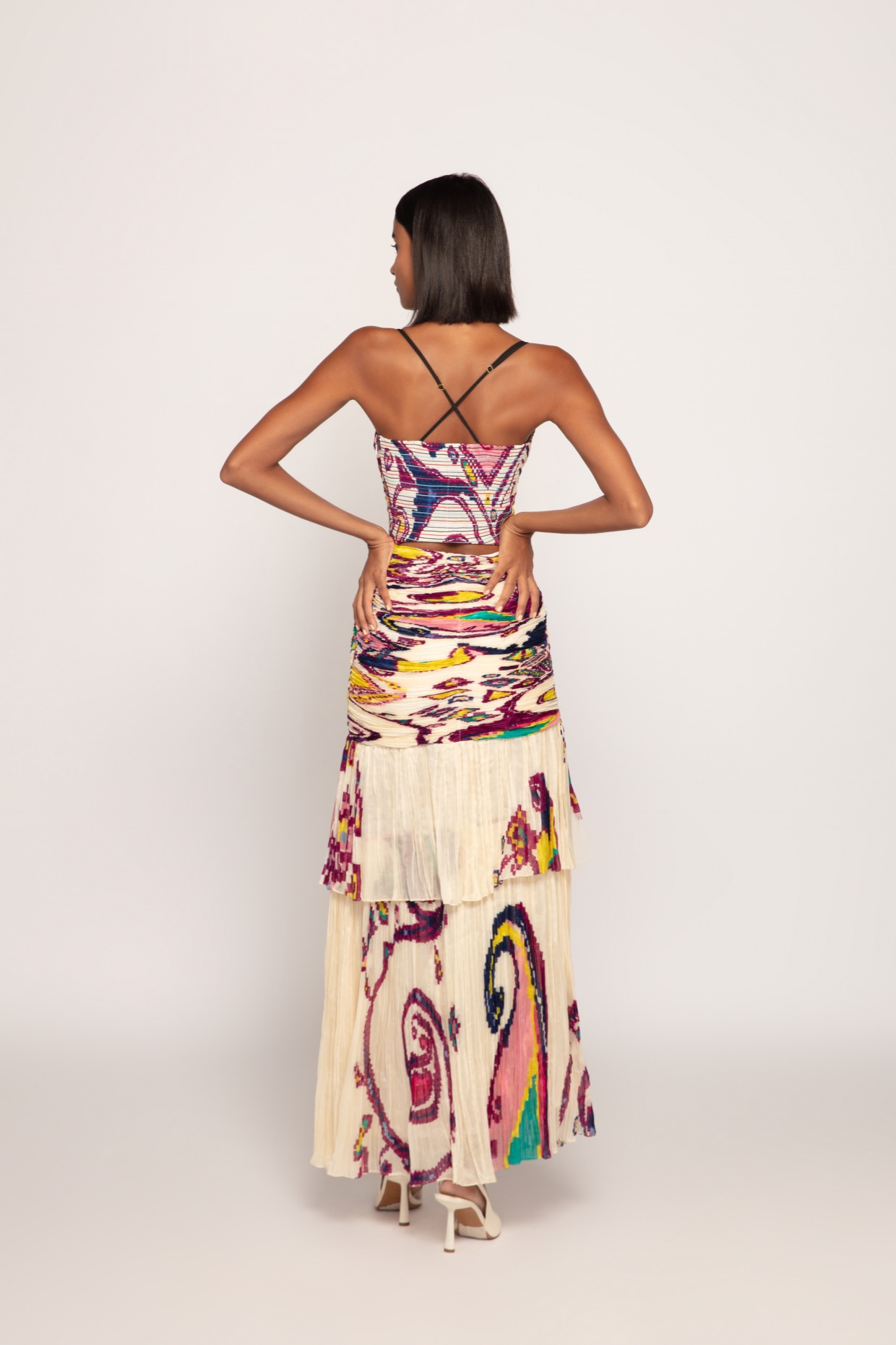 A model showcasing Paisley Print Ivory Tiered Dress by Saaksha And Kinni from Saaksha And Kinni's collection