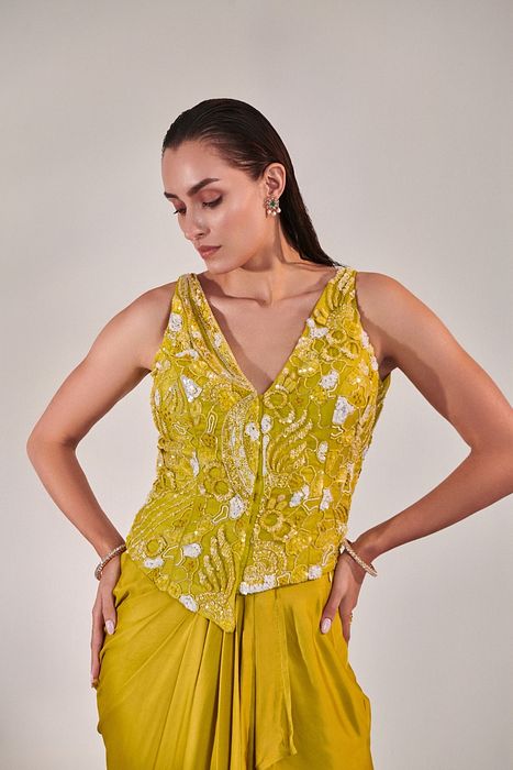 A model showcasing Jacket And Drape Skirt Set In Lime Yellow by One Knot One from One Knot One's collection