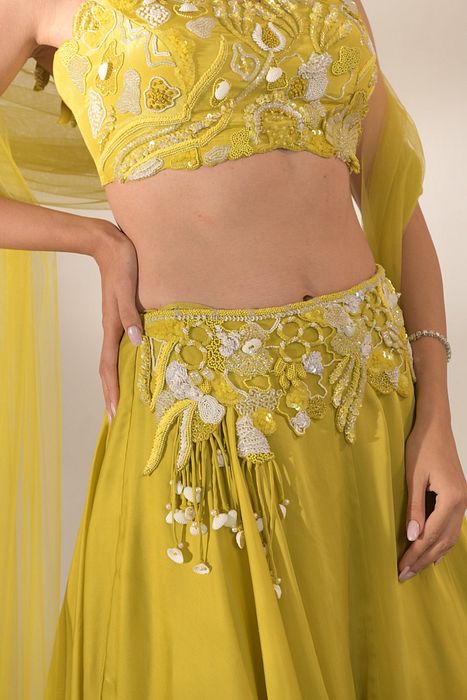 A model showcasing Off Shoulder Cutwork Lehenga Set In Lime Yellow by One Knot One from One Knot One's collection