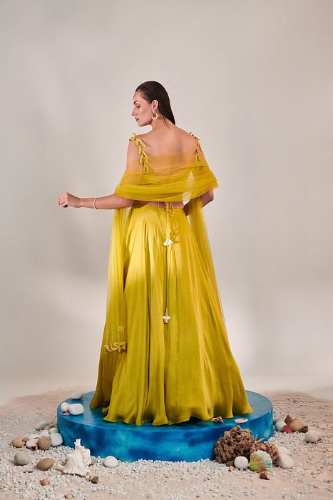 A model showcasing Off Shoulder Cutwork Lehenga Set In Lime Yellow by One Knot One from One Knot One's collection
