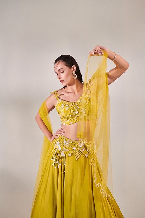 A model showcasing Off Shoulder Cutwork Lehenga Set In Lime Yellow by One Knot One from One Knot One's collection