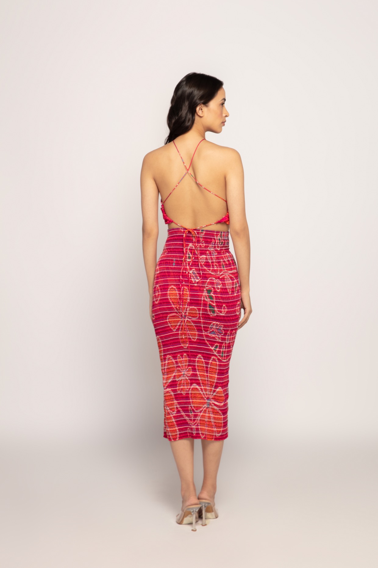 A model showcasing Marigold Print Halter Neck Bralette by Saaksha And Kinni from Saaksha And Kinni's collection