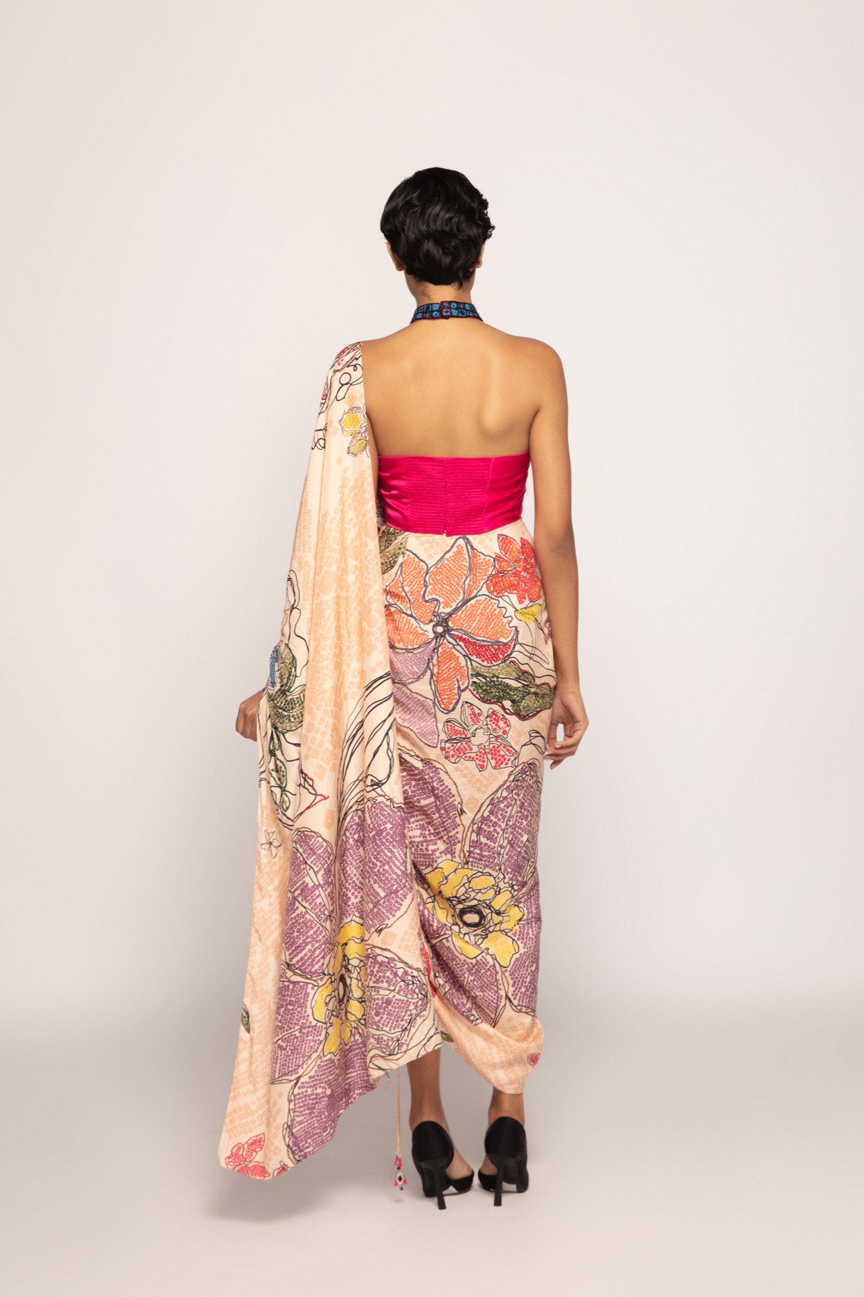 A model showcasing Hot Pink Halter Neck Hand Embroidered Blouse by Saaksha And Kinni from Saaksha And Kinni's collection