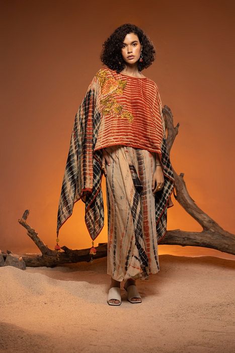 A model showcasing Orange Shikoba Indo Western by Capisvirleo from Capisvirleo's collection