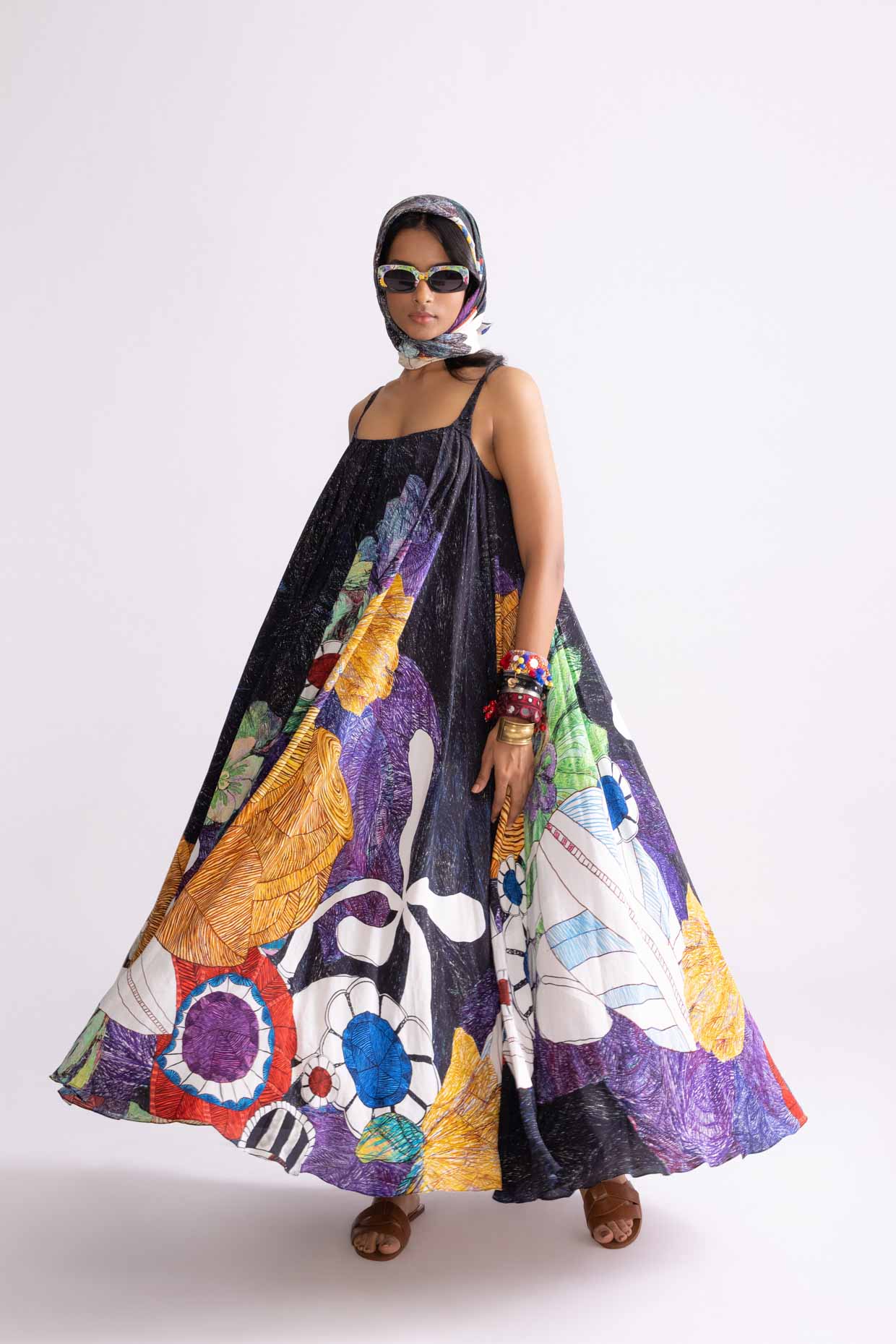 A model showcasing Swing Dress Tribal Print Flared Maxi Dress by Saaksha And Kinni from Saaksha And Kinni's collection