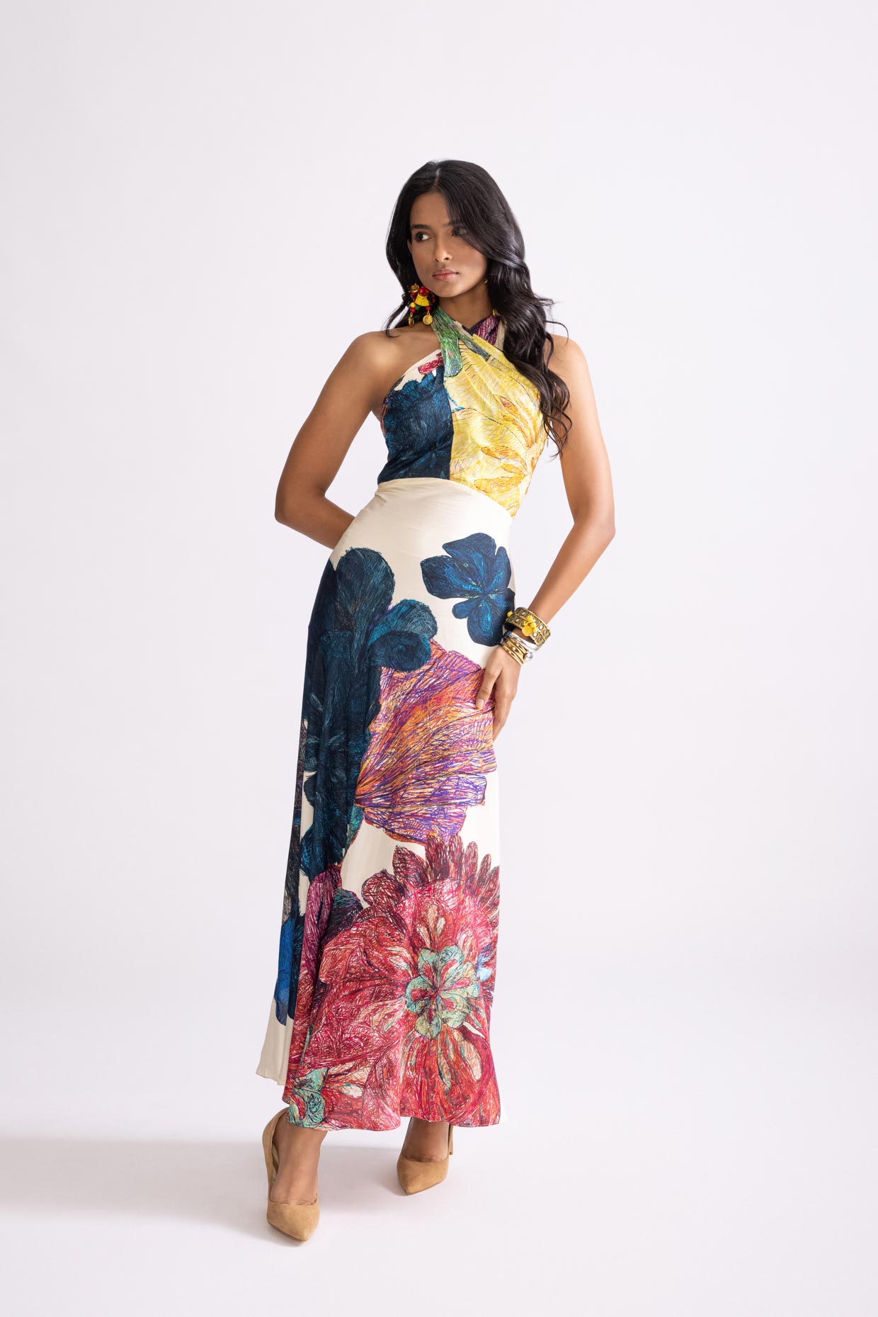 A model showcasing Shailee Dress Daisy Print Halter Neck Dress by Saaksha And Kinni from Saaksha And Kinni's collection